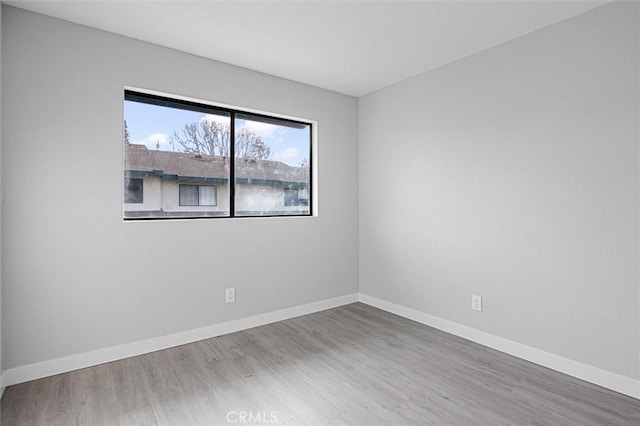 unfurnished room featuring hardwood / wood-style flooring