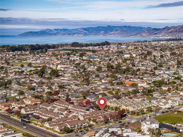 drone / aerial view with a water and mountain view