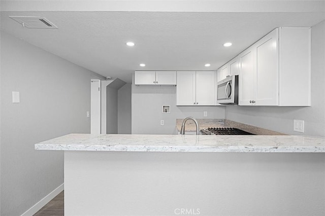 kitchen featuring white cabinetry, dark hardwood / wood-style floors, sink, and kitchen peninsula