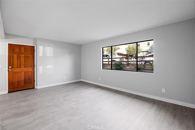 spare room with wood-type flooring