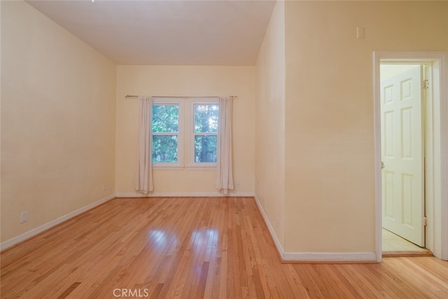 spare room featuring light wood-type flooring