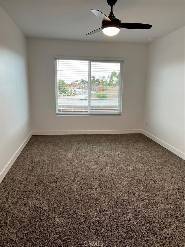 carpeted empty room featuring a wealth of natural light and ceiling fan