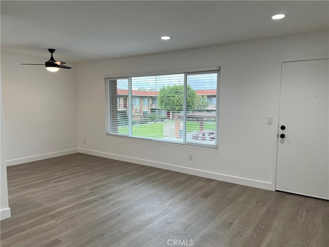 empty room with hardwood / wood-style flooring and ceiling fan