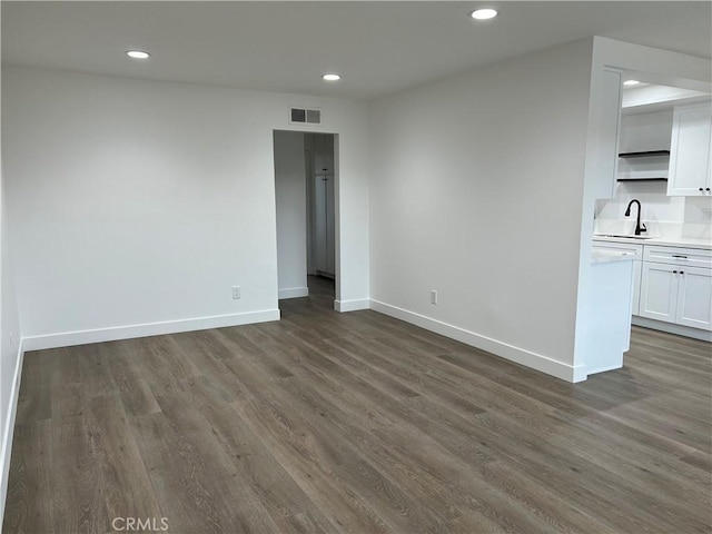 spare room featuring dark hardwood / wood-style floors and sink