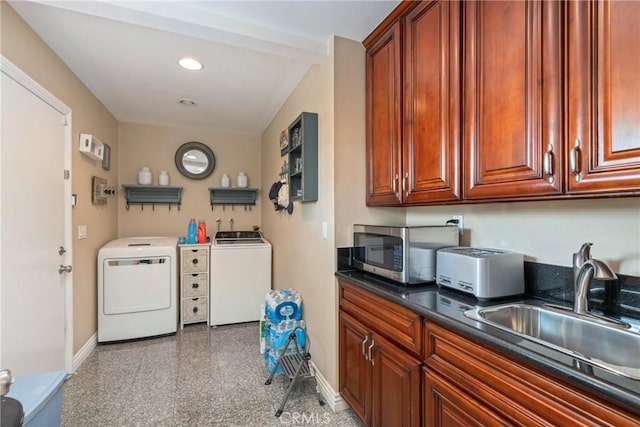 clothes washing area featuring sink and independent washer and dryer