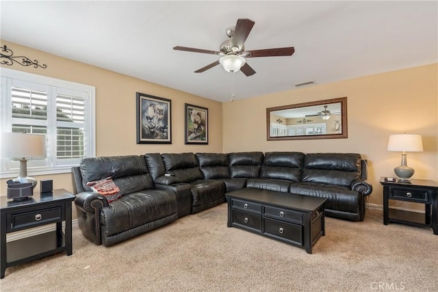 carpeted living room featuring ceiling fan