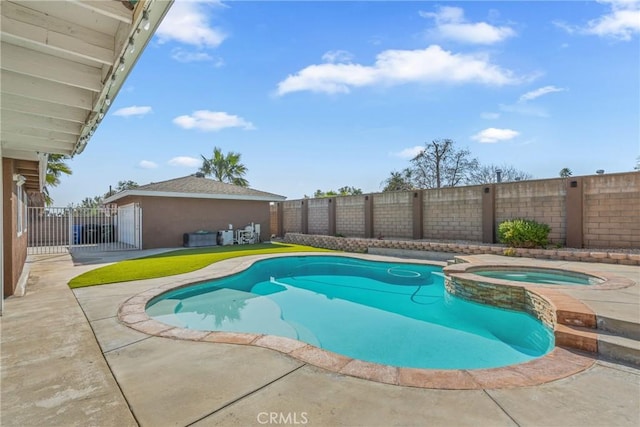 view of swimming pool featuring a patio and an in ground hot tub