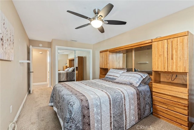 carpeted bedroom featuring ceiling fan and a closet