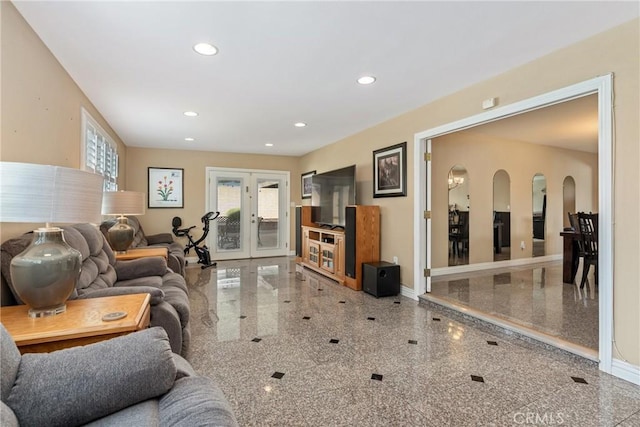 living room featuring french doors and a healthy amount of sunlight