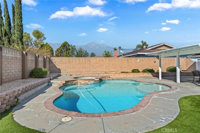 view of swimming pool featuring an in ground hot tub, a mountain view, and a patio