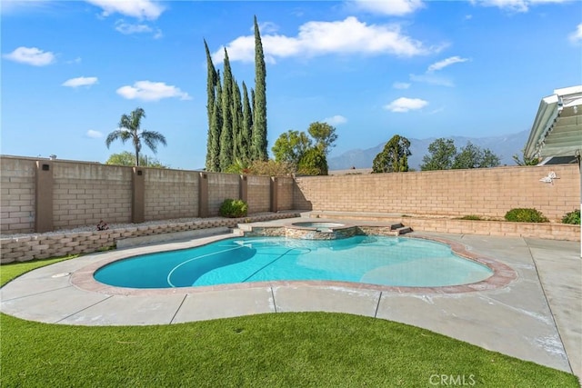 view of pool with an in ground hot tub and a mountain view