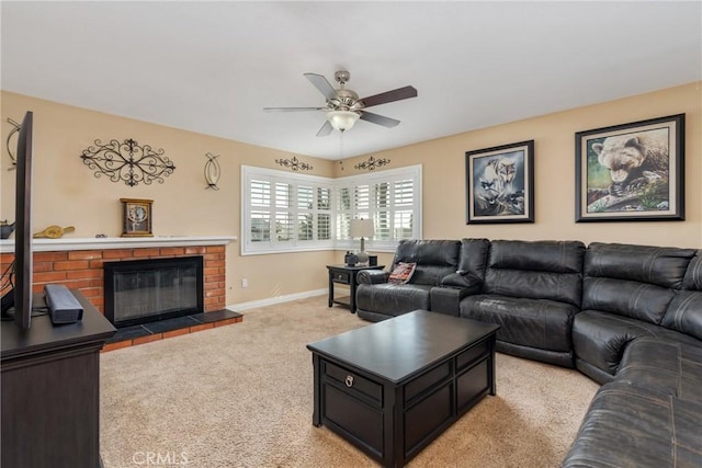 carpeted living room with a brick fireplace and ceiling fan