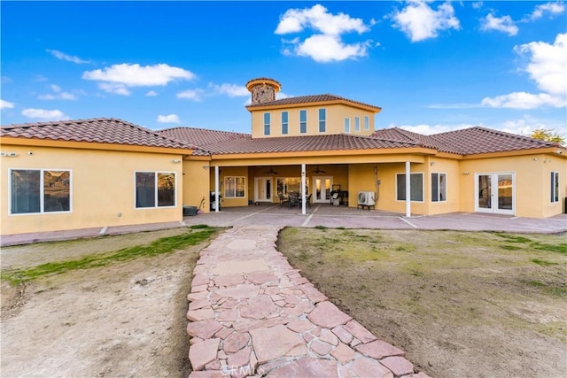 back of property with a patio, french doors, and ceiling fan