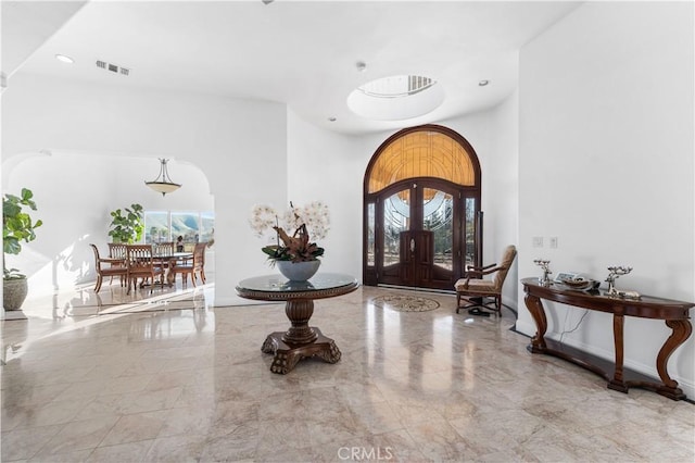 entrance foyer featuring a towering ceiling