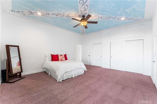 bedroom with multiple closets, ceiling fan, and carpet floors