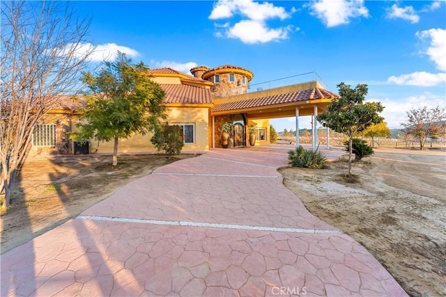 mediterranean / spanish house with a carport