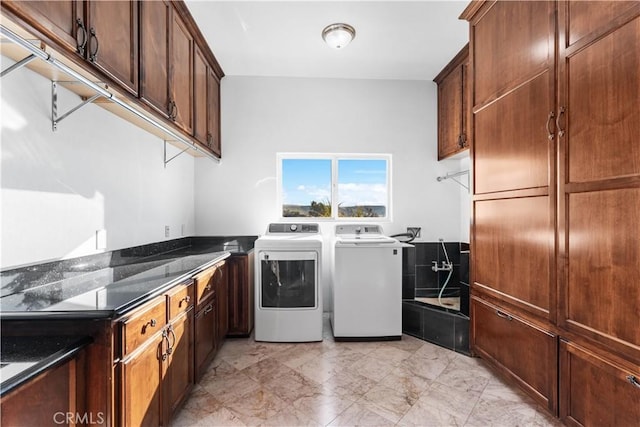 laundry area with cabinets and washing machine and dryer