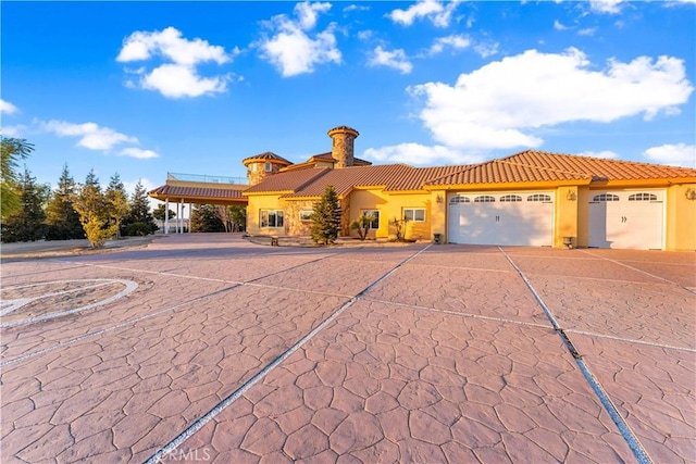 mediterranean / spanish-style home featuring a garage