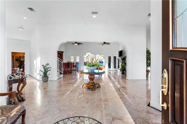 entrance foyer with ceiling fan and a towering ceiling