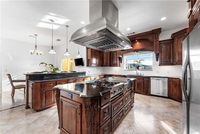 kitchen with pendant lighting, dark stone countertops, stainless steel appliances, island range hood, and a kitchen island