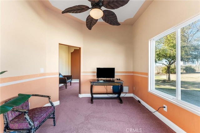 carpeted office space featuring a wealth of natural light and ceiling fan