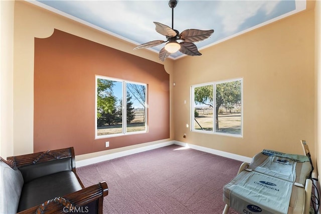 sitting room with ceiling fan, ornamental molding, and carpet flooring