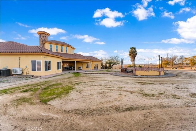 rear view of property featuring ac unit and central air condition unit