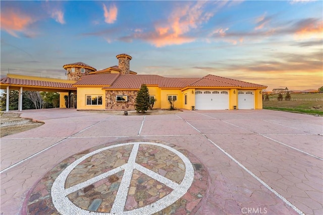 mediterranean / spanish-style home featuring a garage