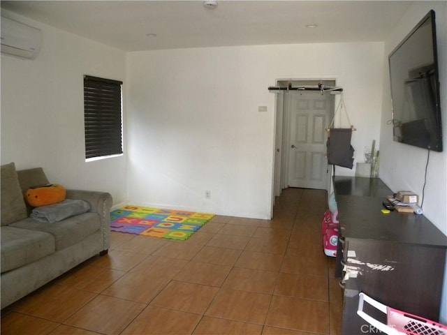 living room with a barn door, tile patterned flooring, and an AC wall unit