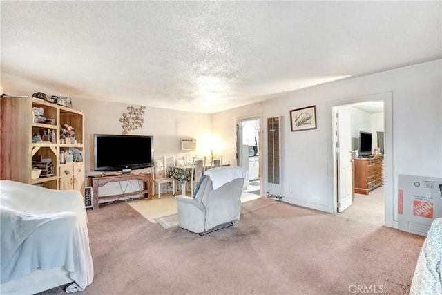 carpeted living room featuring a textured ceiling