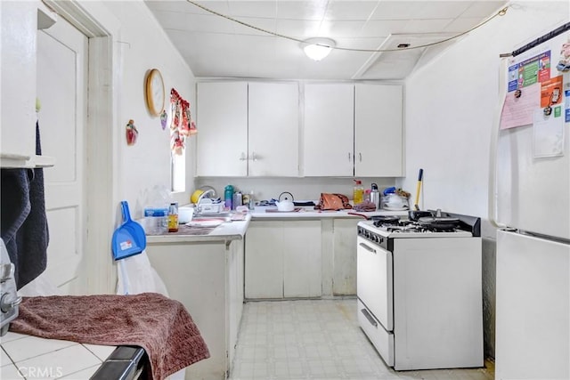 kitchen with white cabinets and white appliances