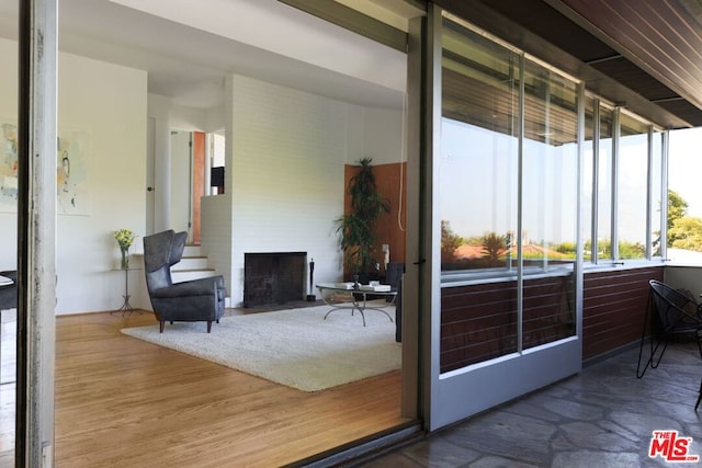 doorway to outside featuring a fireplace and wood-type flooring