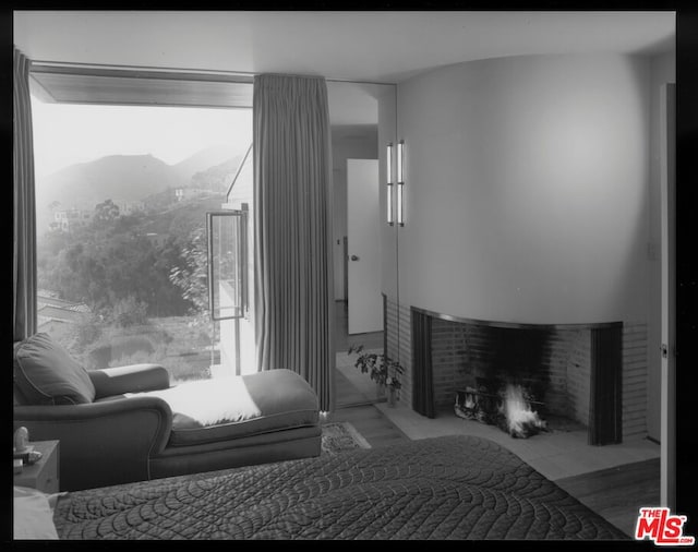 bedroom with multiple windows and a mountain view