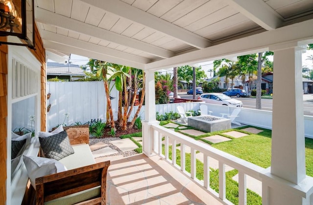 view of patio featuring covered porch and an outdoor fire pit