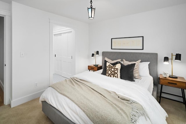 bedroom featuring light carpet and a closet