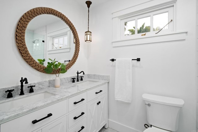 bathroom featuring vanity, plenty of natural light, a shower, and toilet