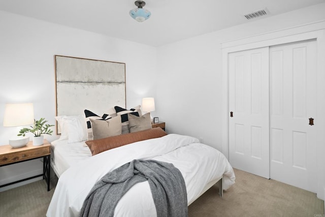 carpeted bedroom with a closet