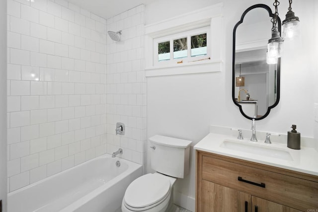 full bathroom featuring vanity, tiled shower / bath, and toilet