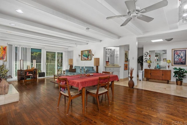 dining space featuring wood-type flooring, beamed ceiling, and ceiling fan