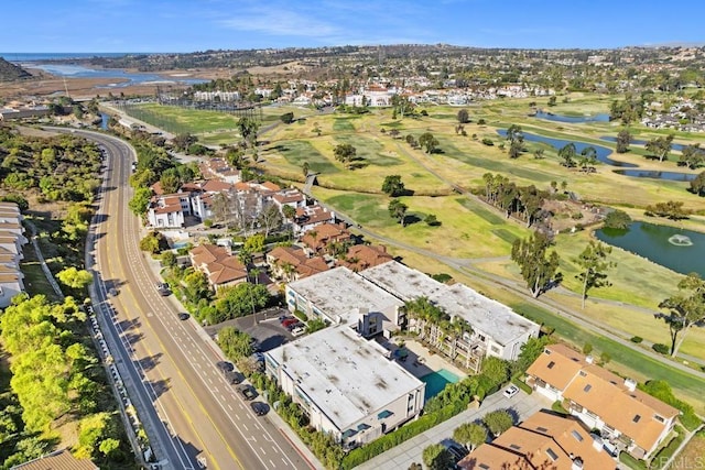 bird's eye view featuring golf course view, a water view, and a residential view