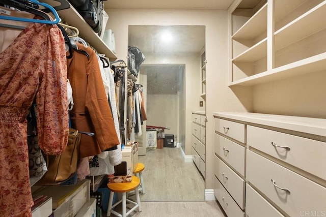 walk in closet featuring light wood-style flooring