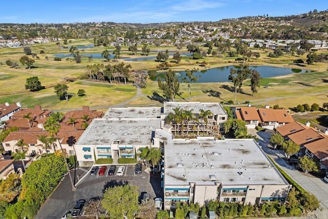 birds eye view of property featuring view of golf course, a water view, and a residential view