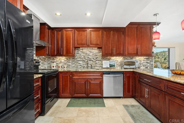 kitchen with reddish brown cabinets, a sink, black appliances, light stone countertops, and wall chimney exhaust hood