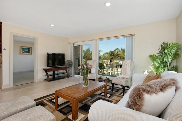 living area featuring baseboards and recessed lighting