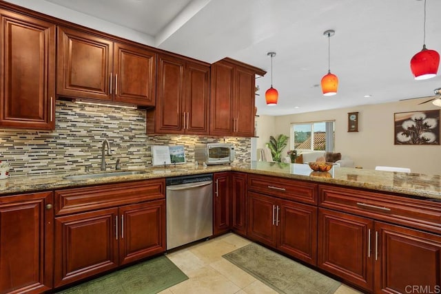 kitchen featuring a sink, hanging light fixtures, stainless steel dishwasher, and dark brown cabinets