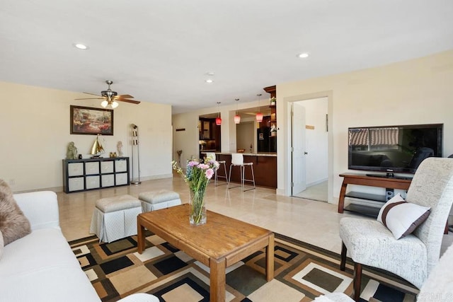 living area featuring baseboards, a ceiling fan, and recessed lighting