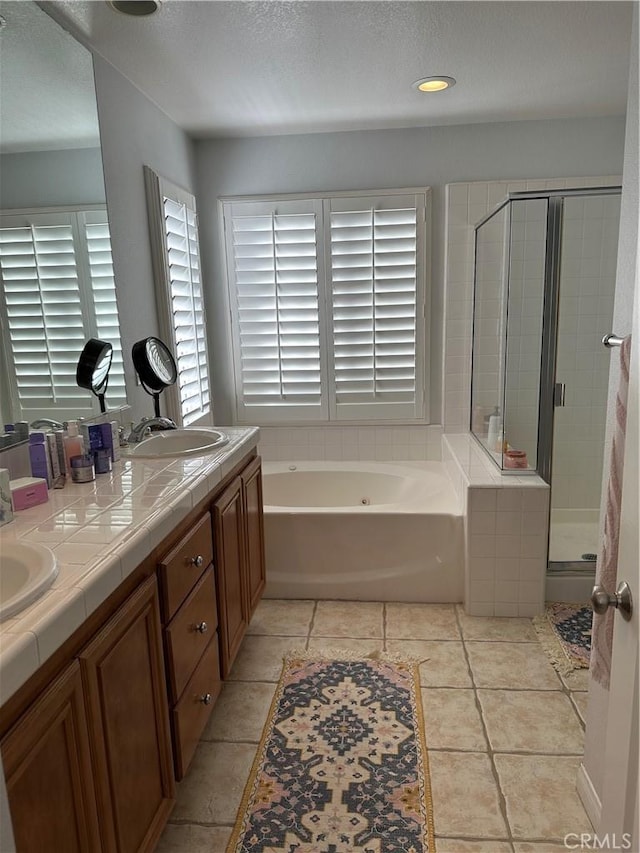 bathroom with shower with separate bathtub, tile patterned floors, and vanity