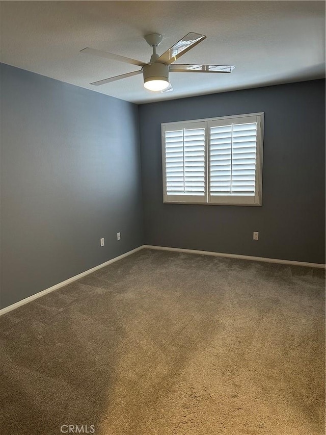 spare room featuring carpet floors and ceiling fan