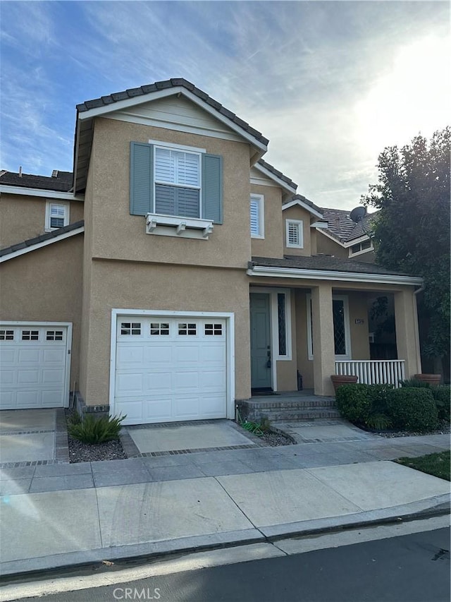 view of front property featuring a garage and covered porch