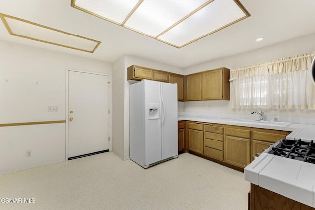 kitchen with white fridge with ice dispenser and sink